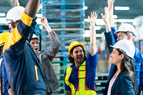 Fotografie Logistics team raising hands in celebration inside warehouse, male and female wo