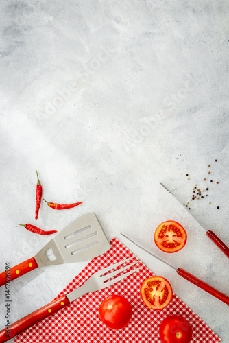Set with barbecue utensils and equipment with red picnic napkin. Stainless steel tools. Top view