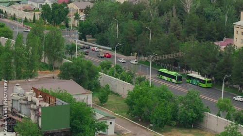 Top-down view of urban traffic at a stoplight. Cars gather, wait at the red light, then continue driving. Captures real-time city road movement and vehicle flow dynamics.