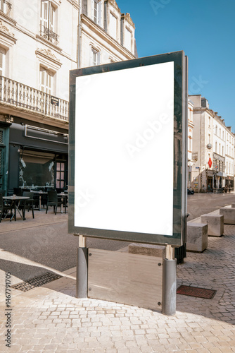 Blank billboard on European street with clear sky - mockup