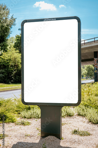 Billboard mockup with JCDecaux branding near bridge and trees - mockup