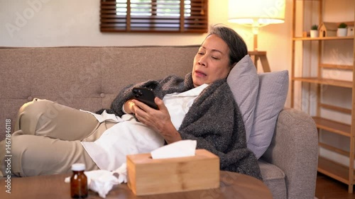 Video 4K Resolution of Senior elderly patient sneezing coughing and pain, flu or sickness with cold or illness in living room