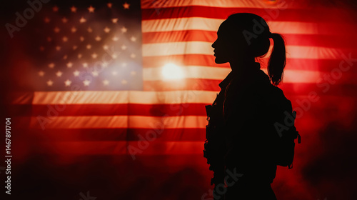 A silhouette of a female soldier with a ponytail, in profile, stands before a large, backlit American flag, creating a somber and patriotic atmosphere