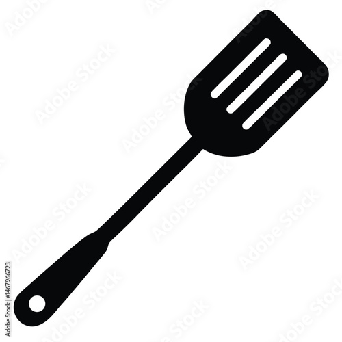 A solid black spatula features three slots at the head with a hole at the handle