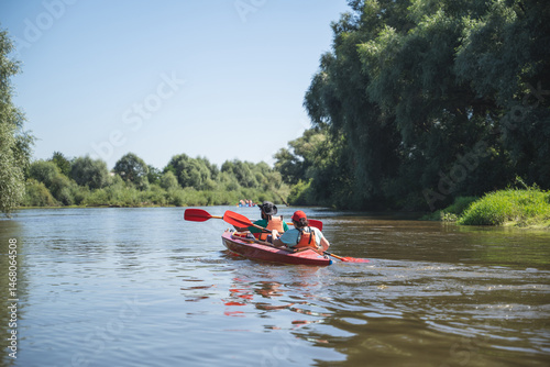 a team of athletes on a canoe overcomes obstacles floating on the river