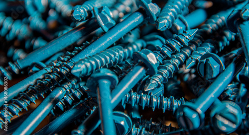 Pile of metal screws left on the workbench in the basement of the house