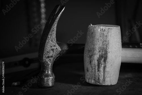 The hammer and mallet on the workbench in the basement of the house