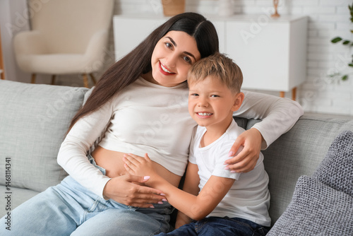 Boy touching mother's belly...