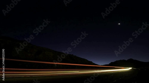 Night Landscape: Dark Mountains, Highway Light Trails, Starry Sky