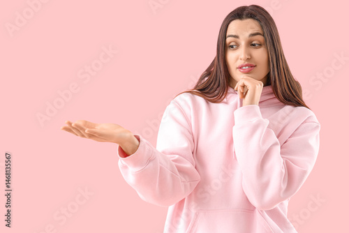 Wondering young woman showi...