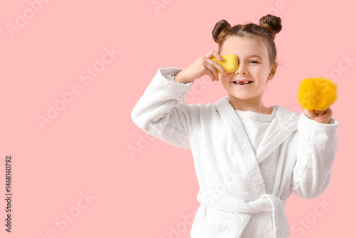 Little girl in bathrobe wit...
