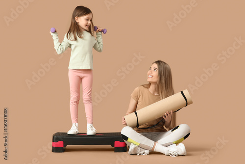 Sporty young mother and her...