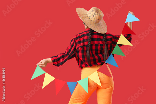 Young woman in straw hat wi...