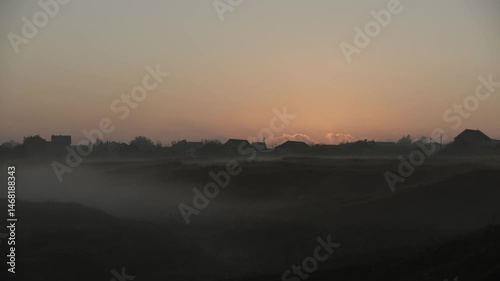 Epic Aerial Flight. Village looks mesmerizing at dawn, with buildings bathing in morning sunlight, forming a breathtaking scape silhouette visible from above.