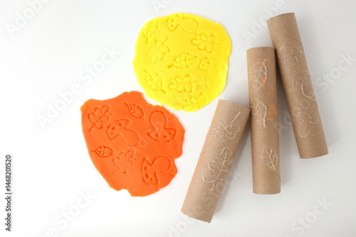 Fotografía Two flattened playdough pieces with leaf, acorn, and mushroom prints next to car