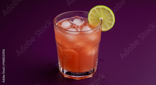 Wallpaper Mural Refreshing Cocktail In A Glass With Ice Cubes And A Lime Slice On A Purple Background Torontodigital.ca