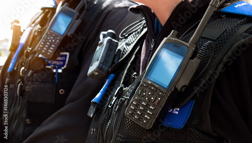 Fotografi Police officers – Close-up of station police officers stab proof vest uniform worn by a couple of department cops at the scene of an incident