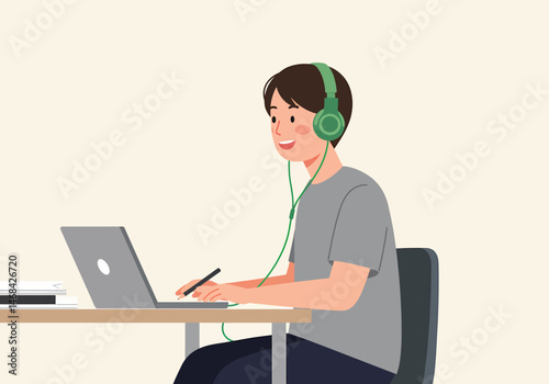 Boy Listening Music With Headphones Using Laptop At Home