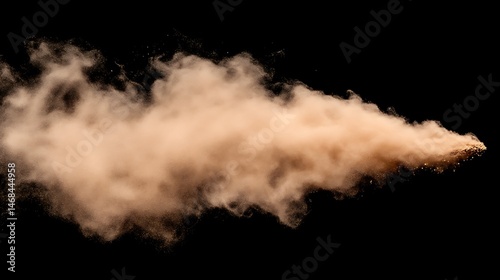 Abstract brown powder explosion creating a dynamic trail on black background
