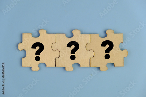 wooden puzzle with a question mark symbol. Concept of question, FAQ, Q and A, confusion and solution. question and answer concept