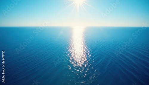 Endless blue expanse meets a sharp, defined horizon line; sunlight bathes the scene , ocean, above, immense