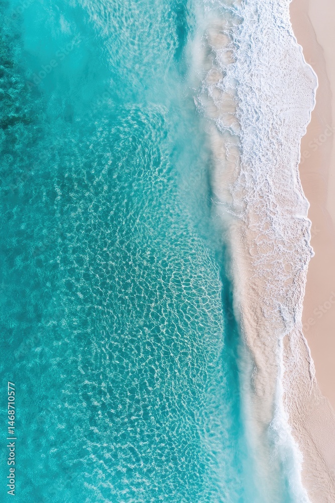 Turquoise ocean waves meet pristine sandy beach