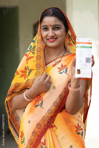 Photography Portrait of Indian rural young woman showing unique identity card at village