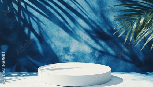 White cylindrical platform against a blue, tropical-themed backdrop with palm shadows