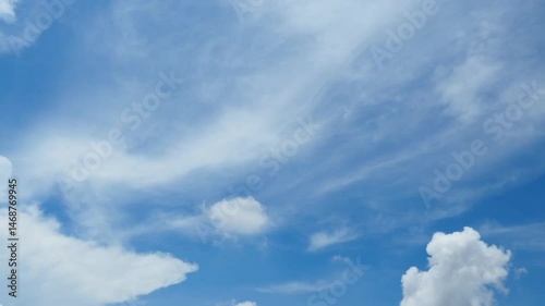 Timelapse image of white clouds and blue sky.