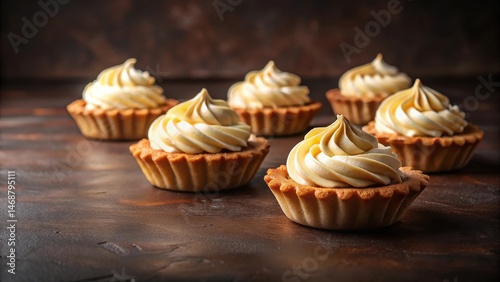 Tartlets with buttercream on a dark brown diagonal background, kitchen decor , desserts