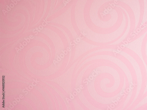  A pink wallpaper with a swirly design is clearly visible in a close-up, taking up most of the imag 