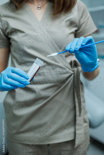 Smear for virus detection. Taking analysis with a smear. Nurse's hands close-up with a smear.