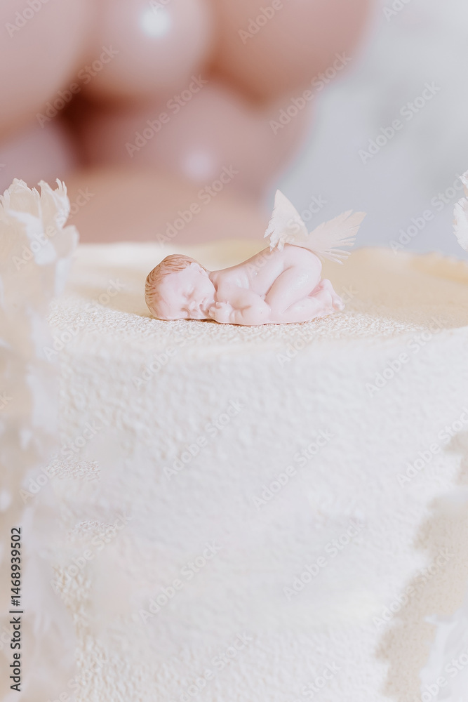 White cake for celebrating a child's baptism. Sweet cake with white wings. Photo zone for a child's baptism.