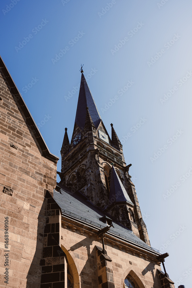 Ancient city buildings. Ancient brick church. Catholic cathedral made of stone.