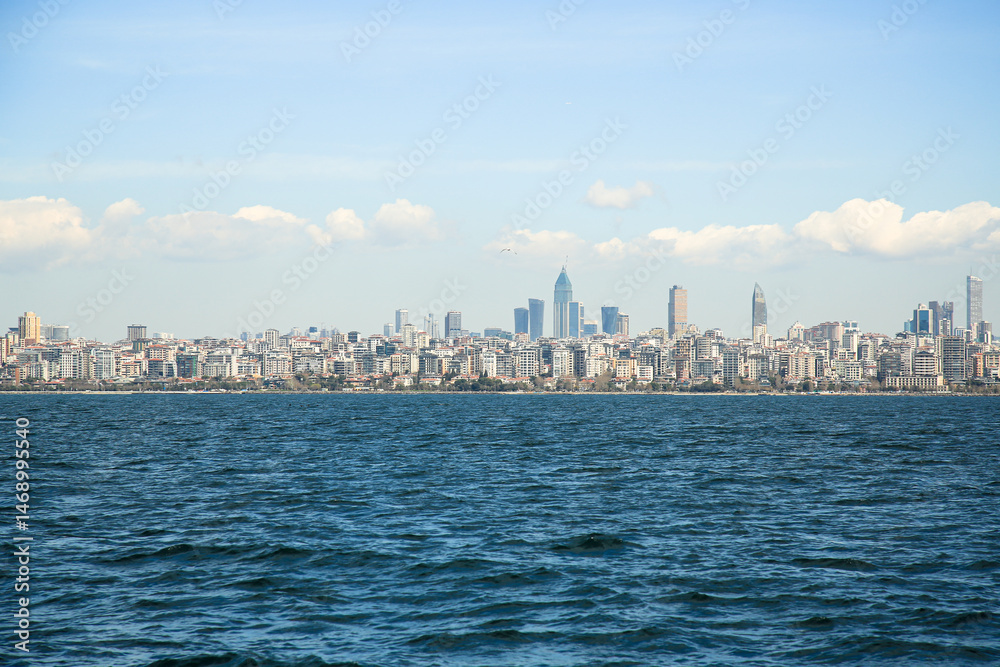 Spring, Istanbul view from the sea. Panorama of the city with a beautiful wave and clouds in the background . high-rise buildings, Turkey Spring, Istanbul view from the sea. Panorama of the city with a beautiful wave and clouds in the background . high-rise buildings, Turkey