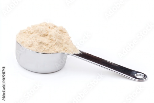 Scoop of protein powder in stainless steel measuring spoon
