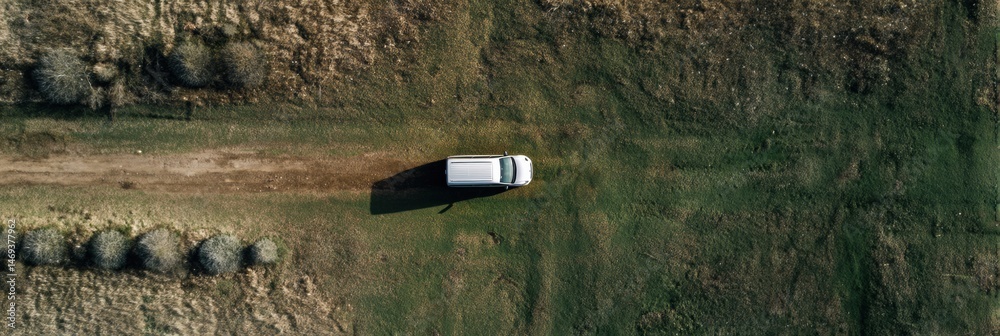Birds-eye View of a Van Parked on a Dirt Path in an Expansive Open Field Under Bright Sunlight Generative AI