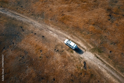 Obraz na płótnie Van Parked in an Open Field Surrounded by Grass and Dirt Roads During a Sunny Day Generative AI w salonie