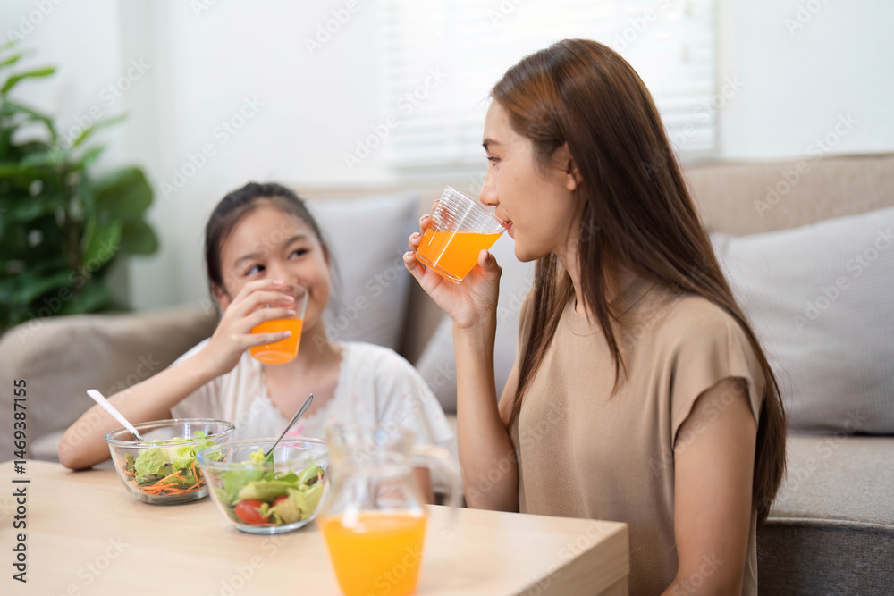 Wellness and healthy lifestyle: Mother and daughter sharing drinks together Wellness and healthy lifestyle: Mother and daughter sharing drinks together