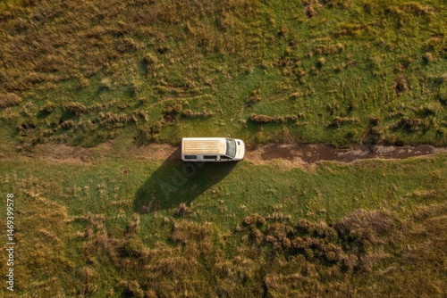 Obraz na płótnie Birds-eye View of a Van Parked in an Open Field Surrounded by Lush Greenery and Natural Terrain During Daylight Hours Generative AI w salonie