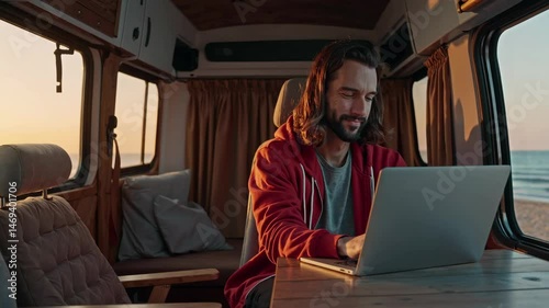 Remote work adventure: man typing on laptop in cozy beachfront camper van interior
