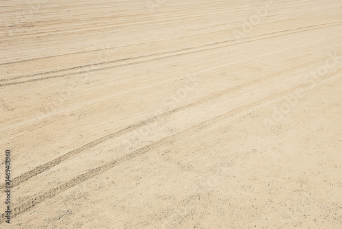 Baseball Infield: Ready For Game. An expansive view of a baseball field infield prior to game time, featuring freshly groomed dirt and tire tracks. This image captures the preparation for the sport.
