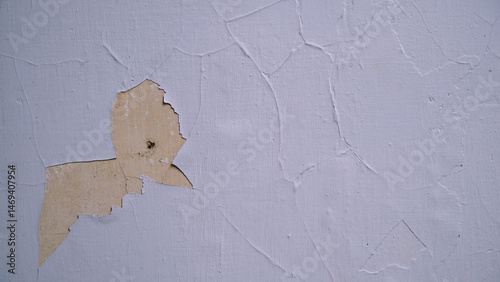 White wall with cracked and peeling surface