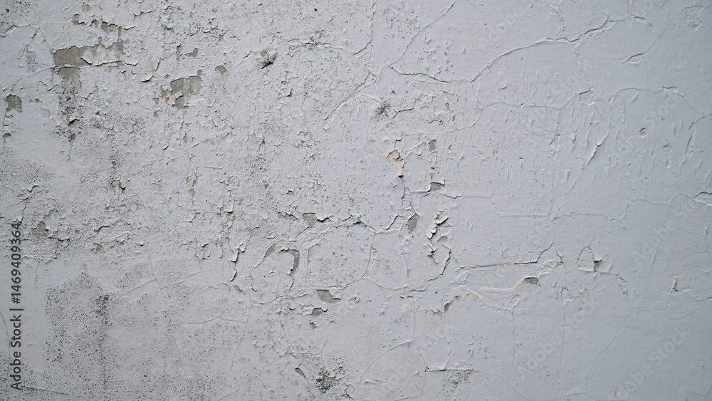 Fototapeta premium White wall with cracked and peeling surface