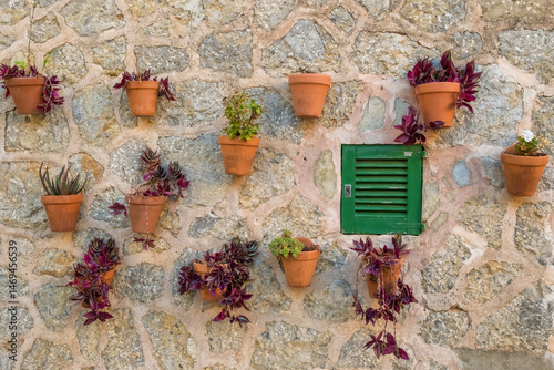 Obraz na płótnie Old stone wall adorned with flower pots in Valdemossa town, Mallorca, Spain w salonie