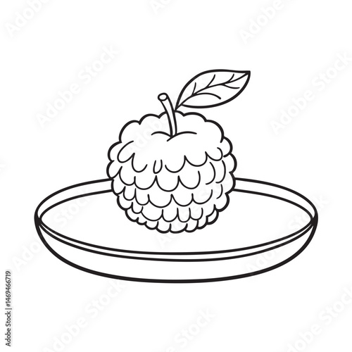Sugar apple with stem and leaves on a round plate