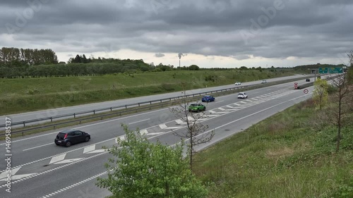 Passing cars on highway strip, close to the city of Ballerup in Denmark photo