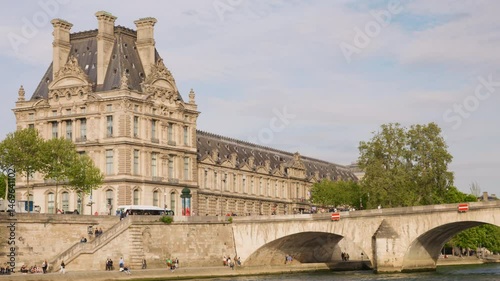 Riverboat cruise on the Seine. View of the Seine River, the embankment, the bridge Pont du Carrousel and building of the Louvre Palace in the 1st arrondissement, Paris, France.