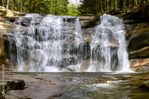 Mumlava Waterfall is located in the Czech Republic in the Mumlava Valley near Harrachov, a mountain resort in the Krkonoše Mountains, where the wild mountain river Mumlava flows through rocky rapids. 