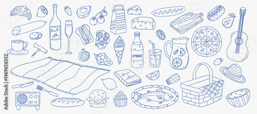 Picnic setup with various foods and items on blanket at outdoor location